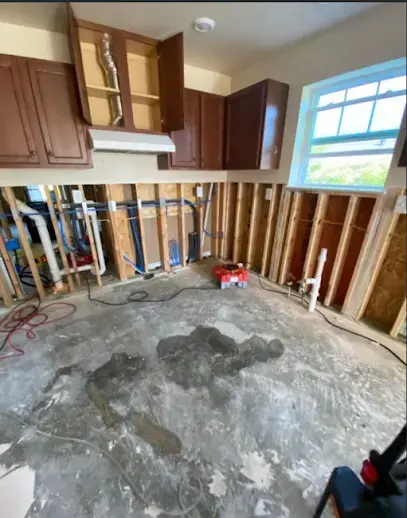 Kitchen opened to the studs with the wet drywall removed for drying